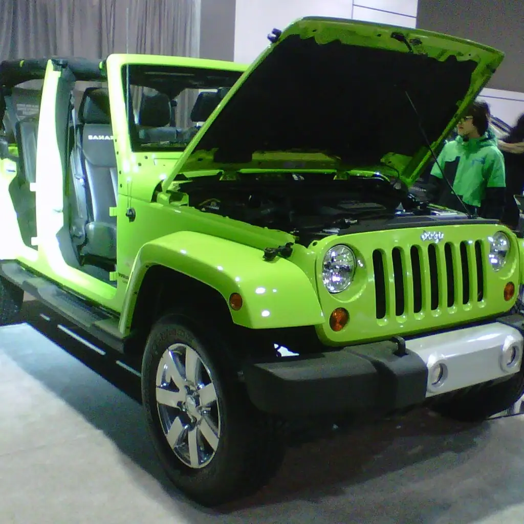 A 2013 Jeep Wrangler Sahara displayed with its doors and roof removed.