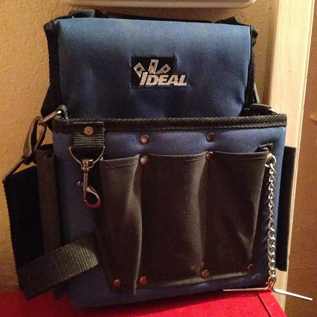 A compact closed tool bag with pockets for small equipment.