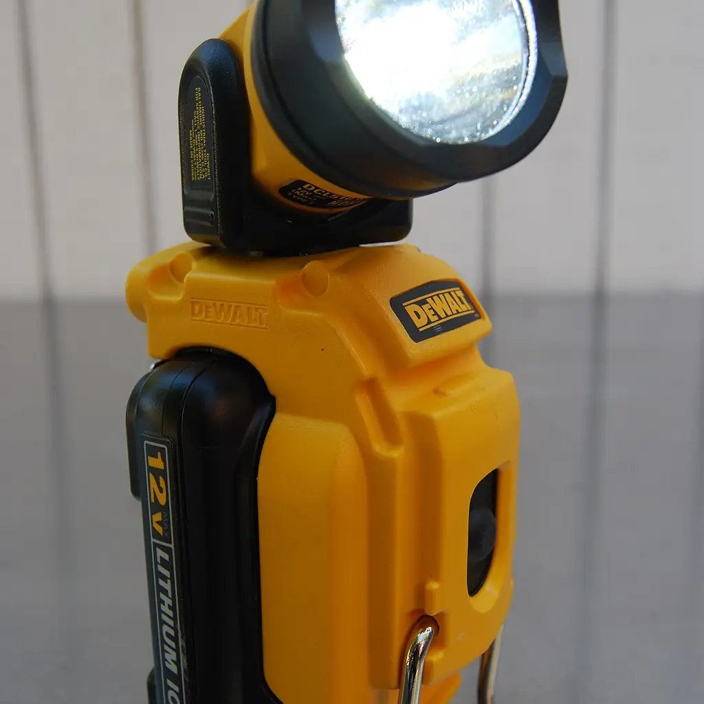 A portable DeWalt work light illuminated indoors.