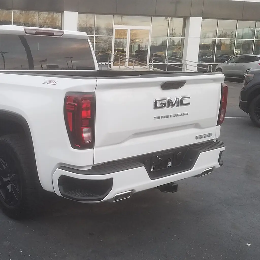 Rear three-quarter view of a 2023 GMC Sierra with its tailgate closed.