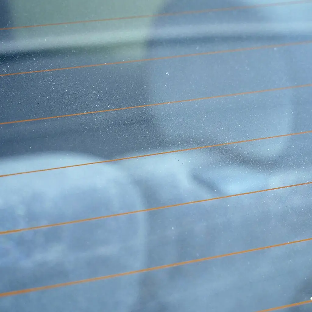 Heating wires running across a car rear window.