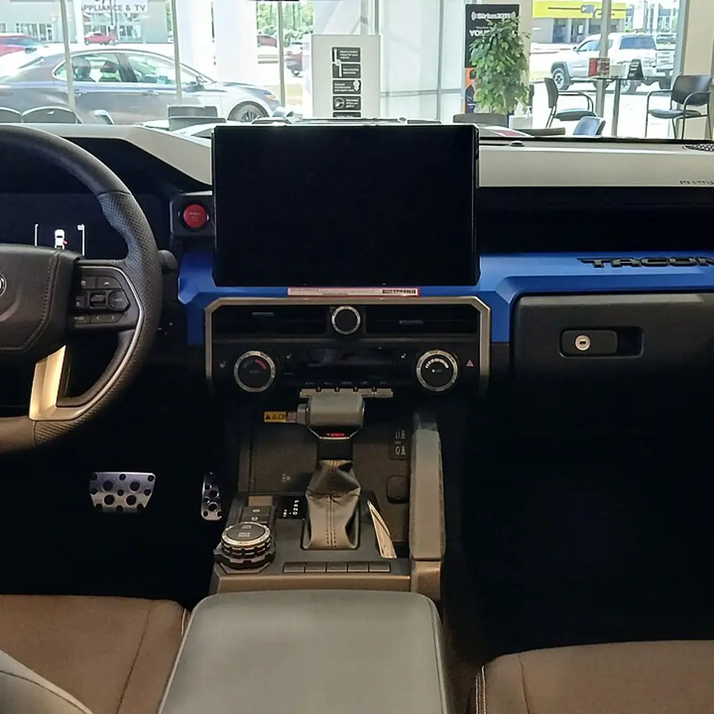 Dashboard, center console and front seats of a 2024 Toyota Tacoma TRD Sport.