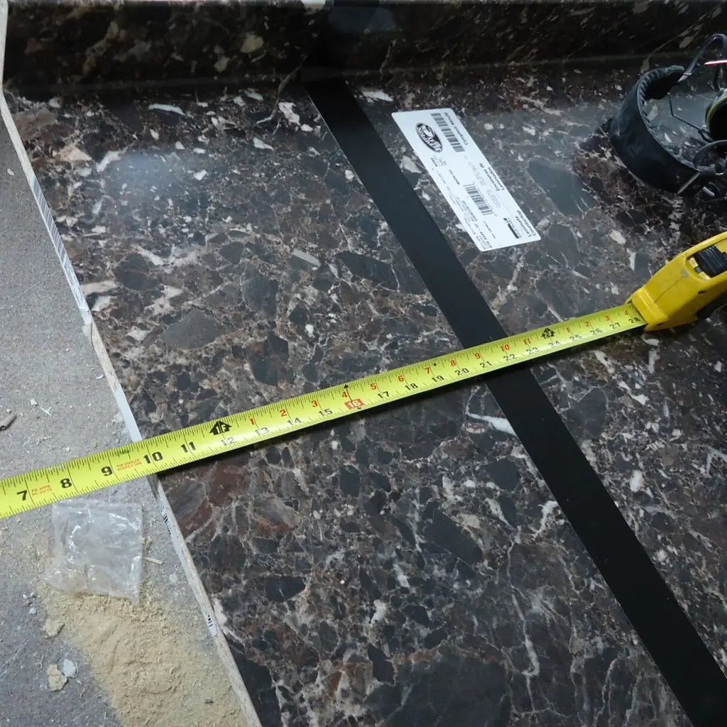 A tape measure laid across a board before cutting.
