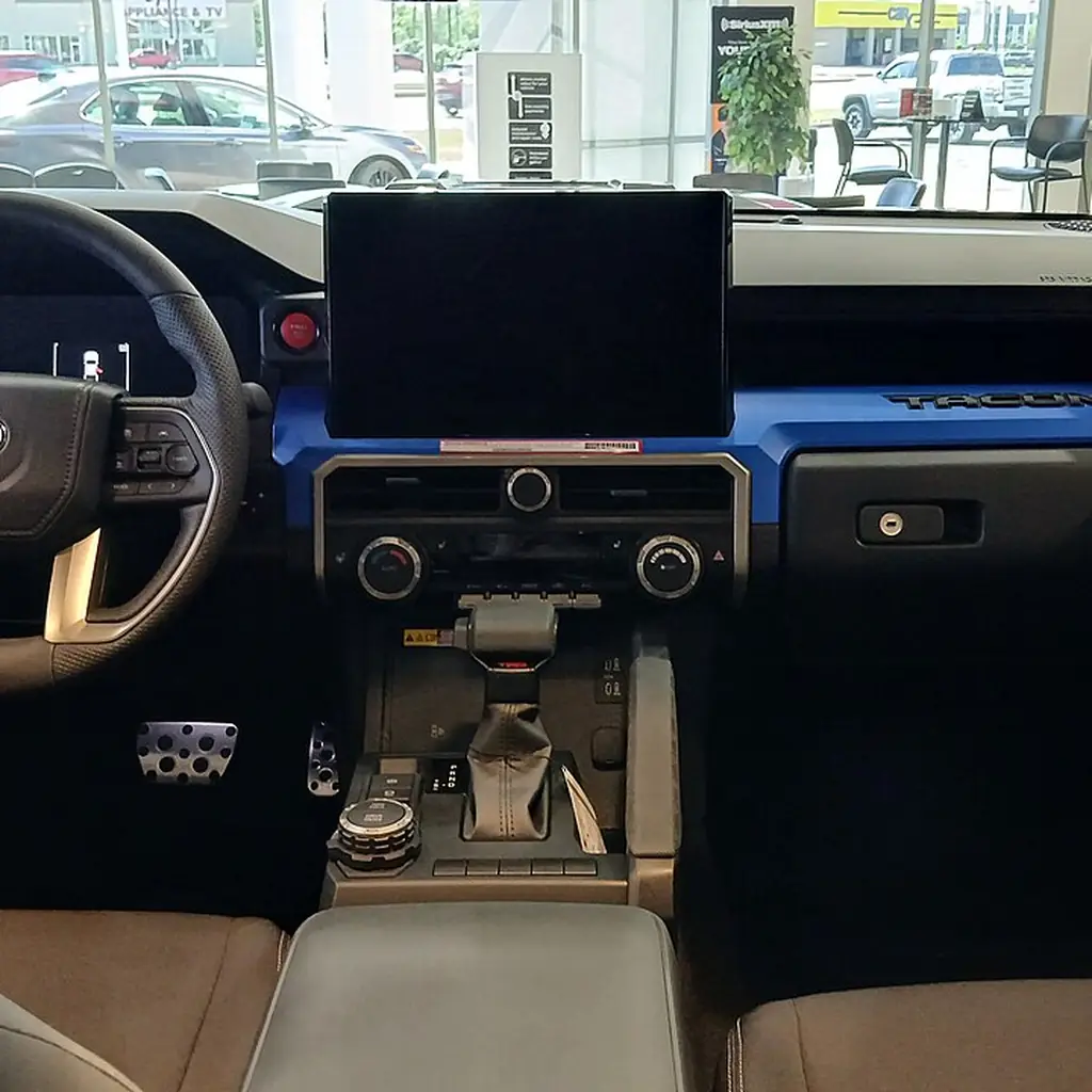 The dashboard and cabin of a 2024 Toyota Tacoma TRD Sport.