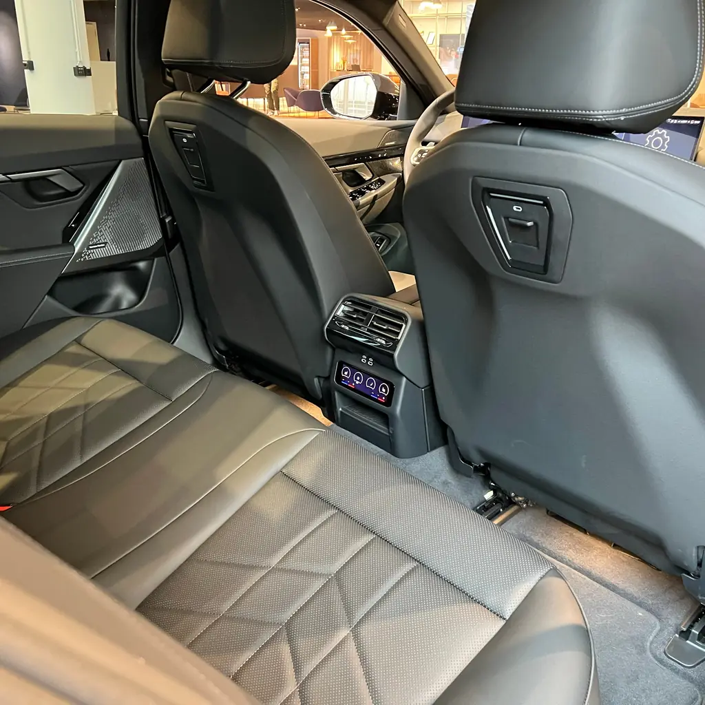 A vehicle rear bench and the backs of the front seats.