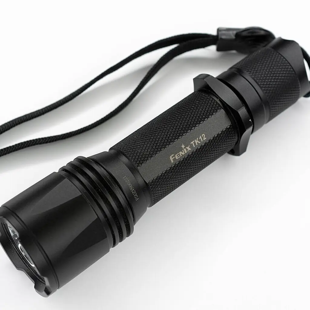 A compact black flashlight with a wrist strap.