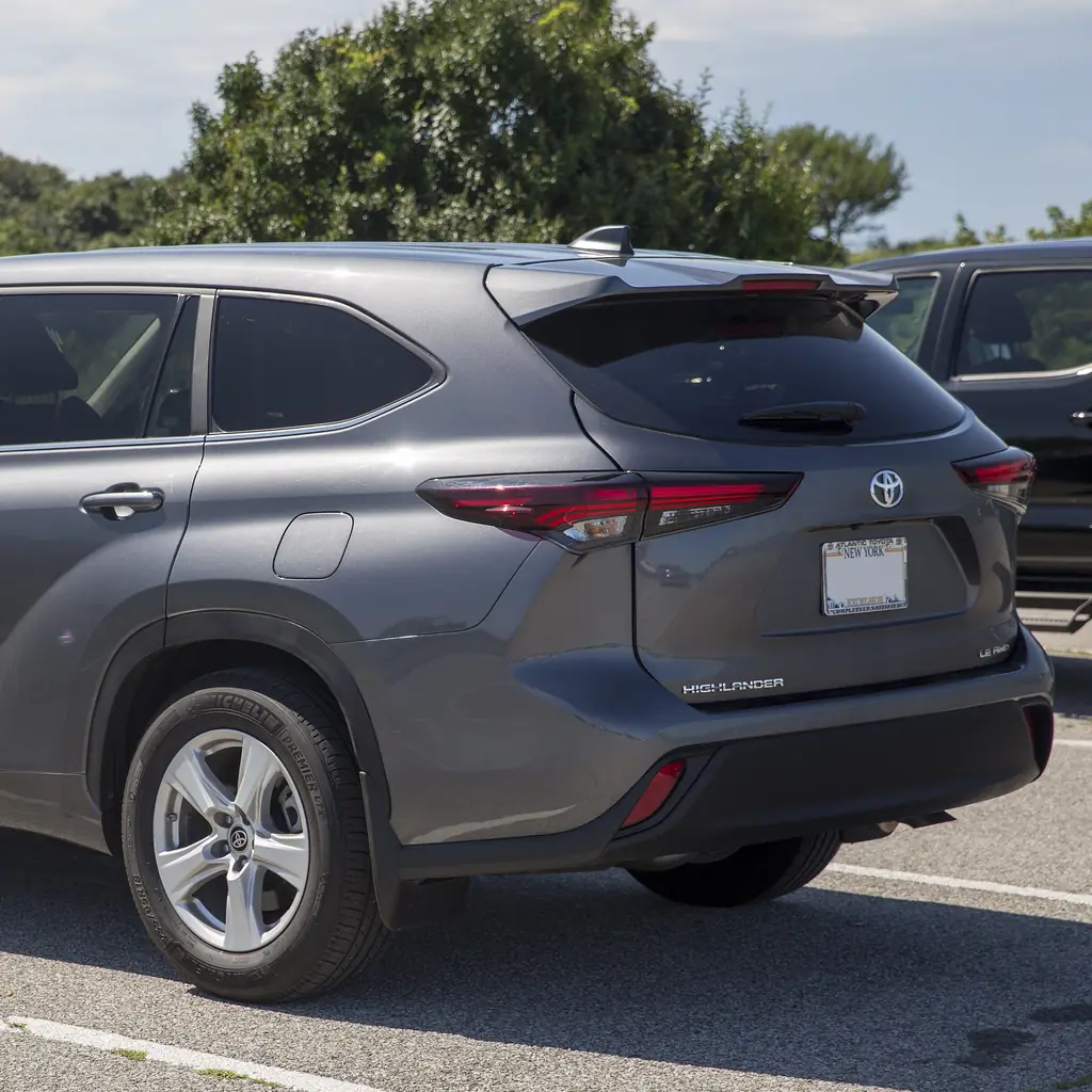 Rear quarter and closed back door of a gray 2024 Highlander.