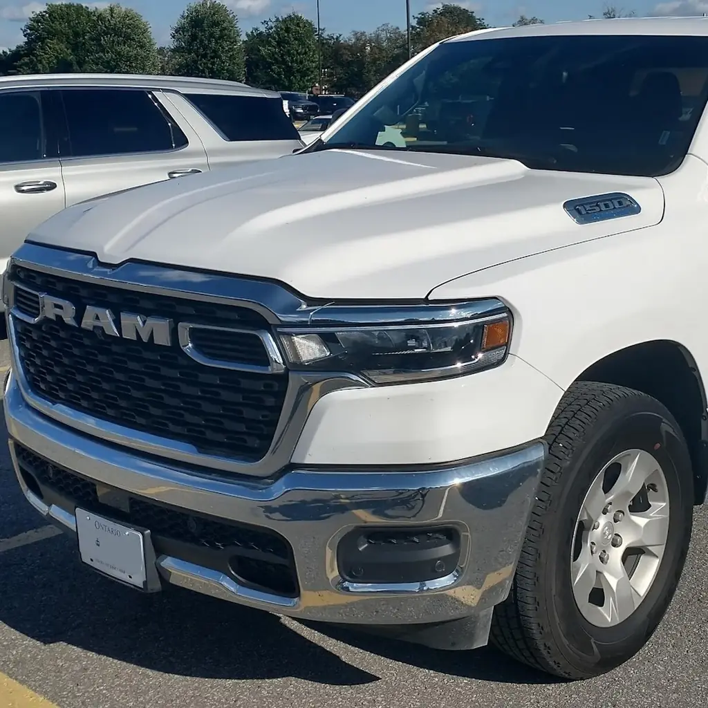 Front quarter of a white DT-generation Ram 1500 Crew Cab.