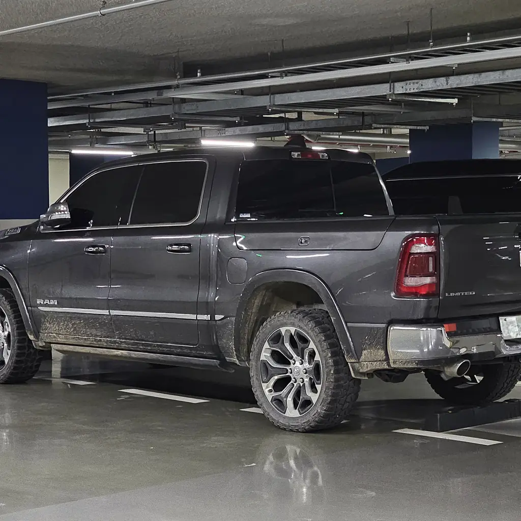 Rear quarter, pickup bed and cab of a gray Ram 1500 Limited.