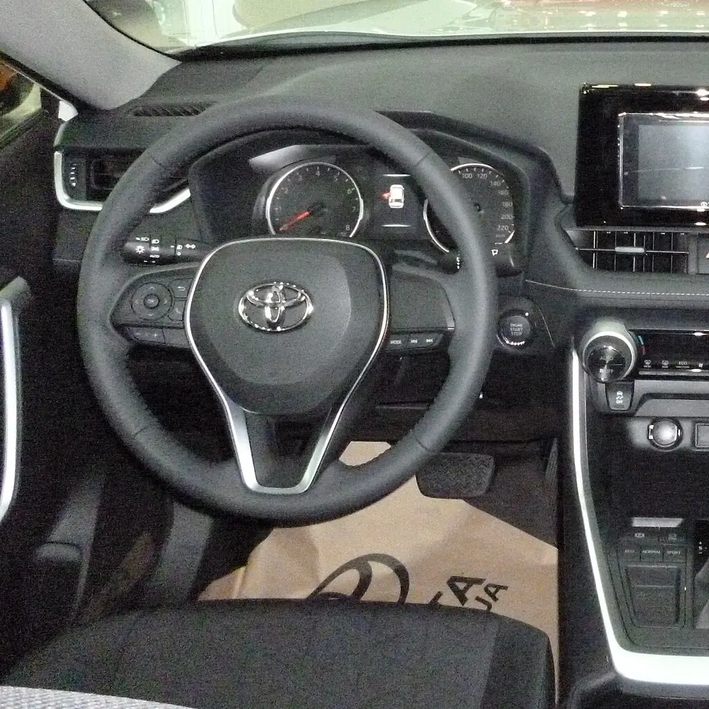 Driver area and steering wheel in a 2019 Toyota RAV4 XLE.